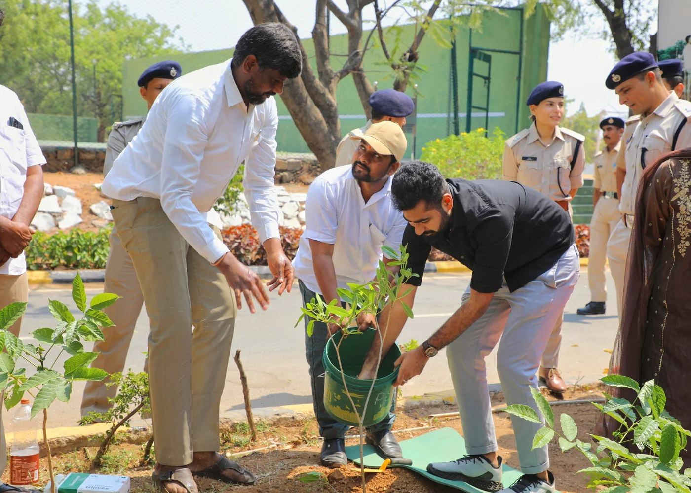 Kadiri Raghu Vamsi planting a tree alongside Indian Police Service officers during a state-coordinated environmental drive